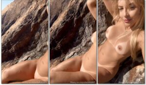 Natalia R, uma loira linda, aproveita a praia de nudismo para se despir e curtir o sol